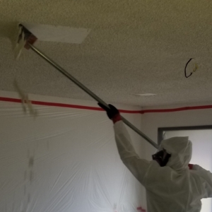 DURING: Popcorn Ceiling Asbestos Abatement. ATHR Technician in Personal Protection Gear. - Mesa, AZ