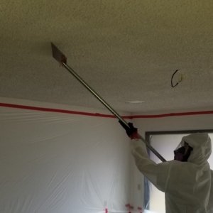 DURING: Popcorn Ceiling Asbestos Abatement. ATHR Technician in Personal Protection Gear. - Mesa, AZ